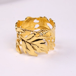 Golden cutout maple leaf napkin ring with polished metal finish for elegant table settings