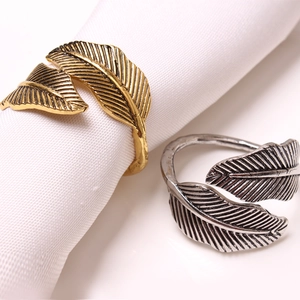 Elegant gold and silver feather napkin rings with detailed leaf texture for table decor
