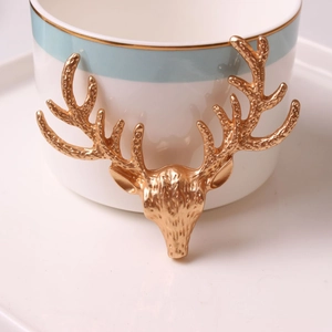 Detailed view of an American-style golden deer head ornament with embossed metallic texture