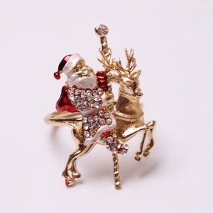 Christmas napkin ring featuring a gold Santa Claus riding a reindeer carousel with rhinestones