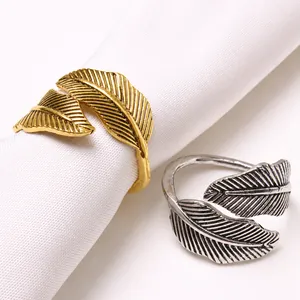 Macro detail of antique gold and silver leaf napkin rings with intricate vein texture