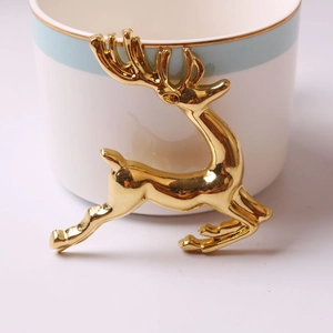 Elegant gold leaping reindeer ornament with polished metallic finish for home decor