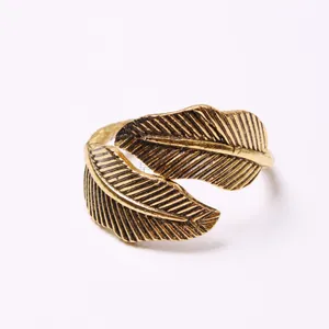 Detailed close-up view of a vintage gold-plated leaf-shaped napkin ring buckle.