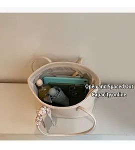 Detailed interior of large cream tote bag showing capacity for tablet and daily items