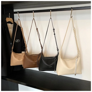 Detail display of stylish lychee texture hobo bags in four colors on a retail rack