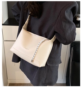 Close-up of cream white lychee texture tote bag with fashion and classic woven strap detail