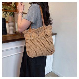 Detail of hollow woven cotton rope bag with leather handles for beach vacation style