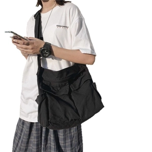 Black canvas crossbody bag with adjustable strap and large front pocket flap