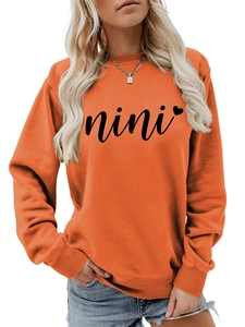 Close-up of crewneck sweatshirt with nini script and heart print in orange