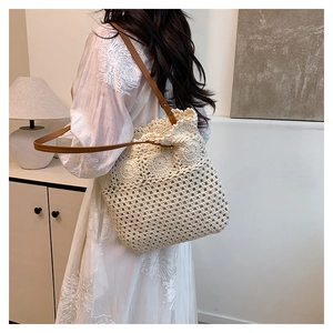 Close-up of beige crochet sunflower tote bag with brown leather strap and rivet details