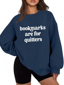 Close-up of navy blue sweatshirt showing 'bookmarks are for quitters' text and fabric