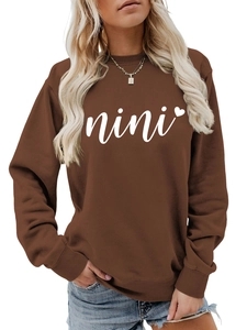 Detailed close-up of dark brown sweatshirt with white nini text and heart graphic