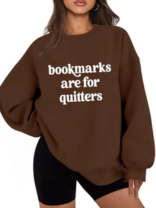 Detail of dark brown sweatshirt featuring white bold Bookmarks Are For Quitters print