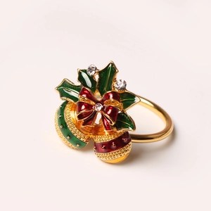 Golden Christmas napkin ring with enamel bell, holly leaves and bow with rhinestones