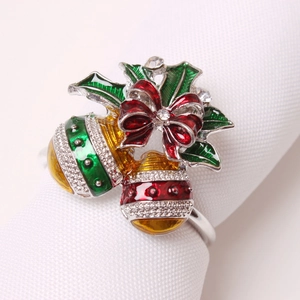 Christmas napkin ring with festive red bells, green holly leaves and sparkling rhinestones