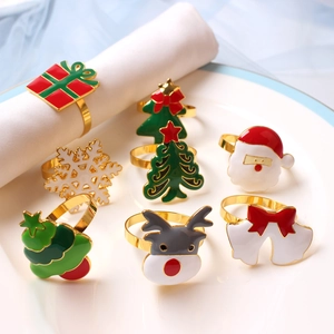 Detail showing various festive Christmas napkin rings on white ceramic plates