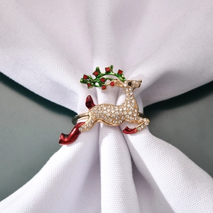 Sparkling Christmas reindeer napkin ring with rhinestones and colorful enamel on a napkin