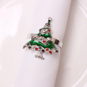 Detailed view of a green enamel Christmas tree napkin ring with colorful rhinestones