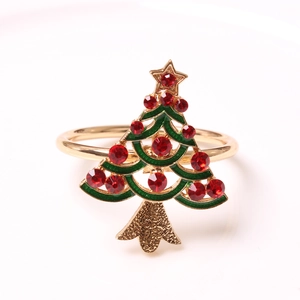 Detailed macro of a green enamel Christmas tree napkin ring with red crystal accents