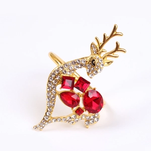 Detail of gold reindeer napkin ring featuring vibrant red gems and sparkling rhinestones