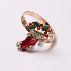 Close-up of Santa boot napkin ring with red enamel and sparkling rhinestones for table decor