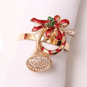 Christmas trumpet napkin ring with gold metal base, red enamel bow and sparkling rhinestones