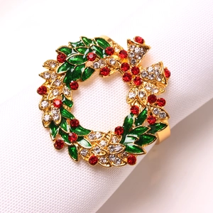 Elegant Christmas wreath napkin ring with green enamel, red crystals and a gold bow detail