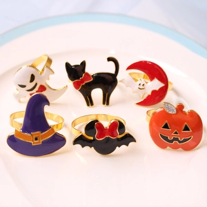 Macro shot of Halloween napkin rings featuring ghost, pumpkin, and bat designs on a plate