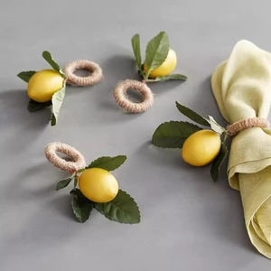 Realistic lemon napkin rings with green leaves and jute rope for dining table decor