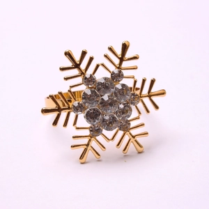 Macro shot of golden snowflake napkin ring with sparkling crystals for table decor