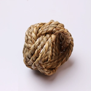 Natural woven corn husk napkin ring with thick rustic texture on white background
