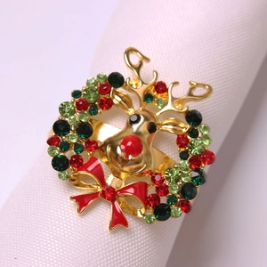 Macro detail of Christmas reindeer napkin ring with colorful rhinestones and red enamel bow