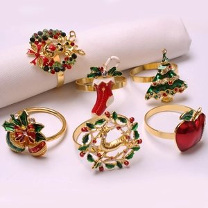 6-piece festive Christmas napkin ring set with reindeer, tree and bell designs in gold