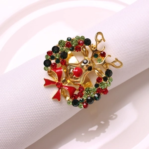 Detailed view of reindeer head napkin ring with colorful rhinestones and red enamel bow
