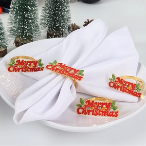 Set of 4 gold Merry Christmas napkin rings with red letters and green holly leaves