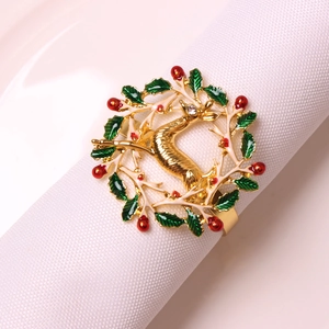 Christmas reindeer napkin ring with golden elk, green leaves and red berries floral wreath