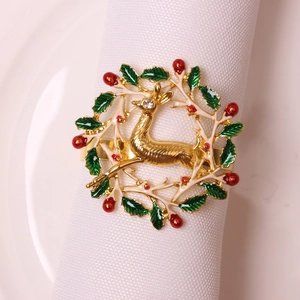 Golden Christmas reindeer napkin ring with green holly leaves and red berries