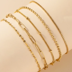 5-piece gold stainless steel bracelet set featuring Figaro and paperclip chain links