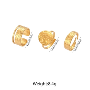 Detailed view of three gold punk geometric rings with hammered and ribbed textures
