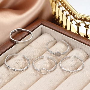 Five-piece set of geometric silver stainless steel open rings in a velvet jewelry box