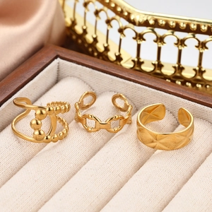 Detailed shot of three gold adjustable rings featuring bead and quilted patterns in a gift box
