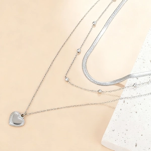 Three-layer silver stainless steel necklace with snake chain and heart pendant on stone
