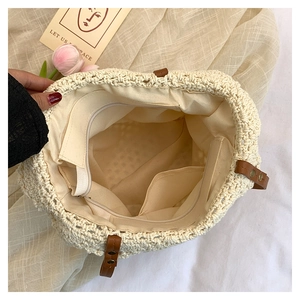 Interior detail of woven tote with fabric lining, zipper pocket, and leather trim