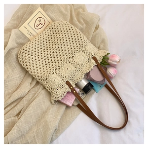 Detail of hollow woven tote bag showing diamond patterns and sunflower base with essentials