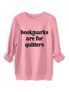 Detail of pink cotton sweatshirt cuff and black bookmarks are for quitters slogan