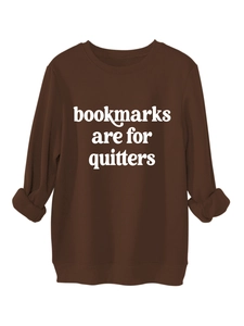 Detail of dark brown crewneck sweatshirt with Bookmarks Are For Quitters slogan print
