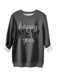 Detail eines dunkelgrauen Fleece-Sweatshirts mit Neujahrs-Pailletten-Text und warmem Futter