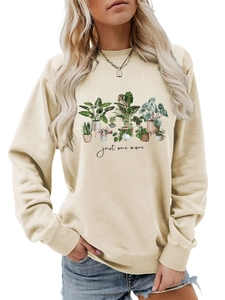 Detail of soft beige sweatshirt featuring a potted plant illustration and slogan print