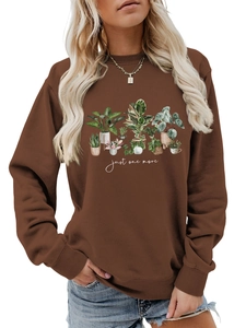 Detail of ribbed crewneck and potted plants print on a brown fleece sweatshirt