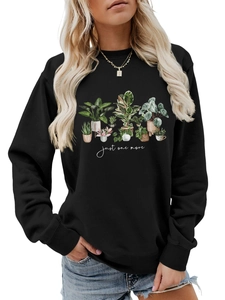 Detail of black crewneck sweatshirt with ribbed cuffs and botanical houseplant graphic